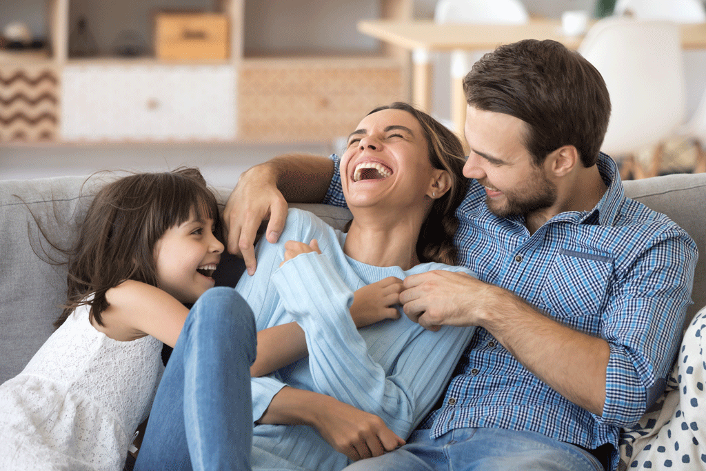 family laughing on couch comfortable at home emergency heating and ac repair bullhead city az kingman az